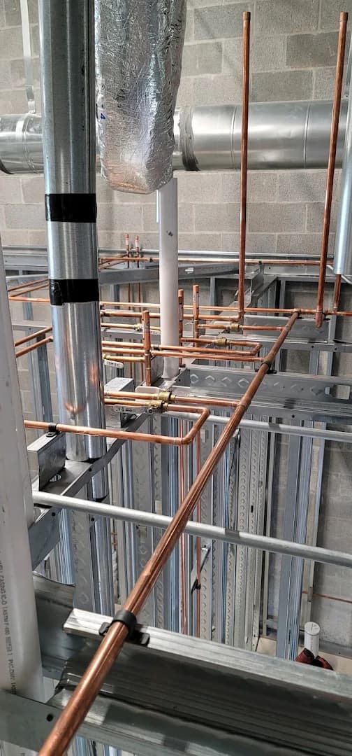 Commercial copper rough-in with valves and ductwork in steel studs